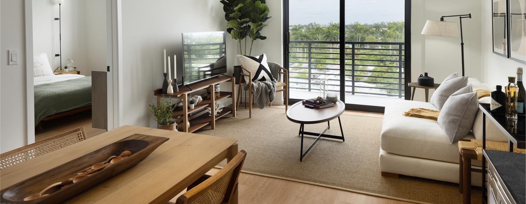 a living room with a large glass door access to private balcony